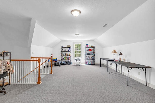 recreation room featuring visible vents, baseboards, carpet flooring, and lofted ceiling