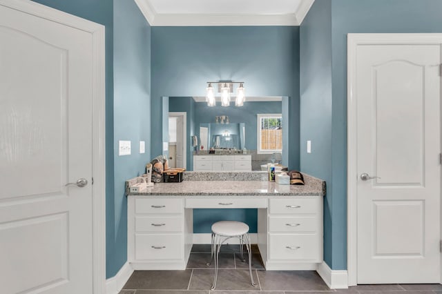bathroom with tile patterned floors, a notable chandelier, vanity, and baseboards