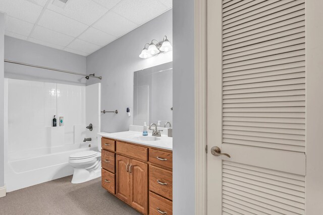 full bathroom featuring a closet, toilet, a paneled ceiling, shower / bathing tub combination, and vanity