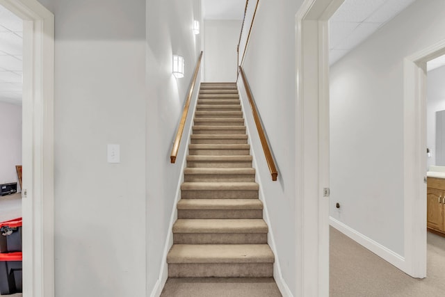 staircase with carpet floors and baseboards