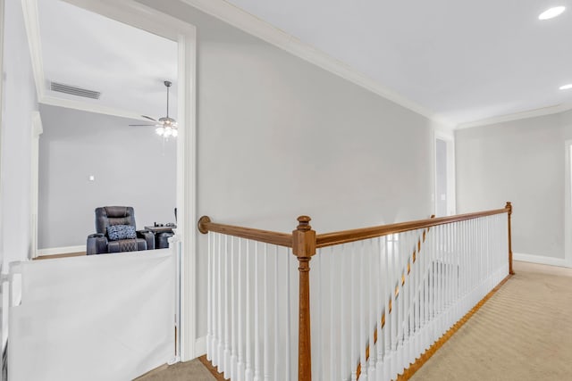 corridor with baseboards, carpet flooring, an upstairs landing, crown molding, and visible vents