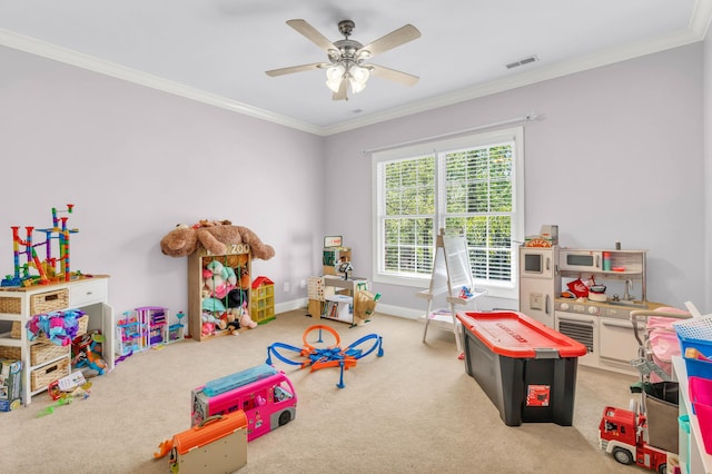 playroom with crown molding, ceiling fan, visible vents, and carpet floors