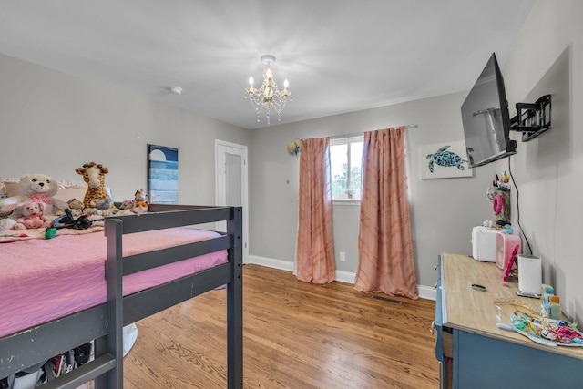 117 Douglas Dr, Chattanooga, TN 37412 - bedroom with baseboards, an inviting chandelier, and light wood-type flooring