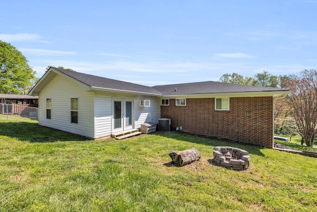 117 Douglas Dr, Chattanooga, TN 37412 - rear view of house with a fire pit, central AC unit, a yard, and french doors