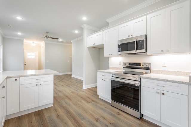 kitchen featuring ornamental molding, ceiling fan, appliances with stainless steel finishes, white cabinetry, and recessed lighting
