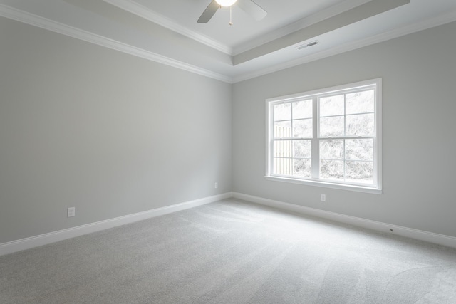unfurnished room featuring crown molding, visible vents, a tray ceiling, and light carpet