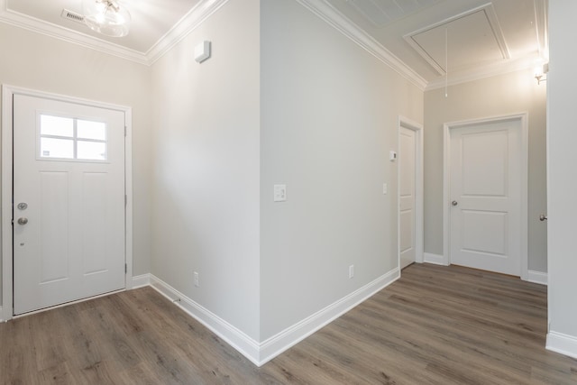 entrance foyer featuring wood finished floors, baseboards, ornamental molding, and visible vents