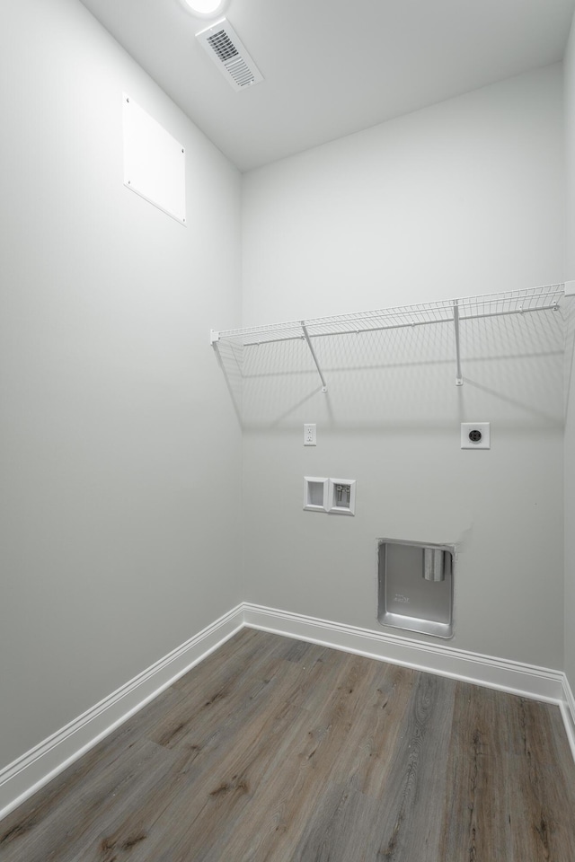 laundry area featuring visible vents, baseboards, laundry area, hookup for an electric dryer, and wood finished floors