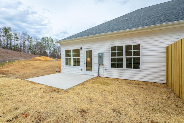back of house with a patio area and a shingled roof