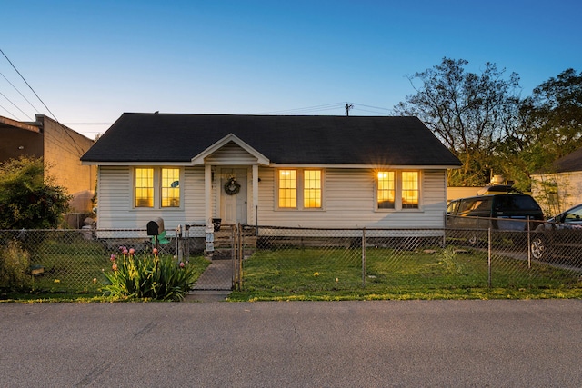 view of front of house with a front yard and a fenced front yard