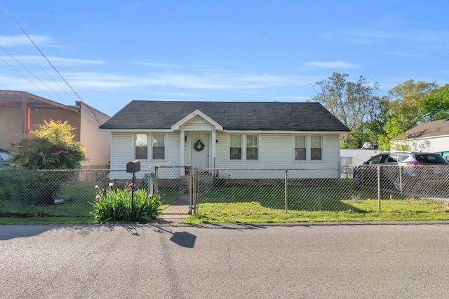 ranch-style house with a gate and a fenced front yard