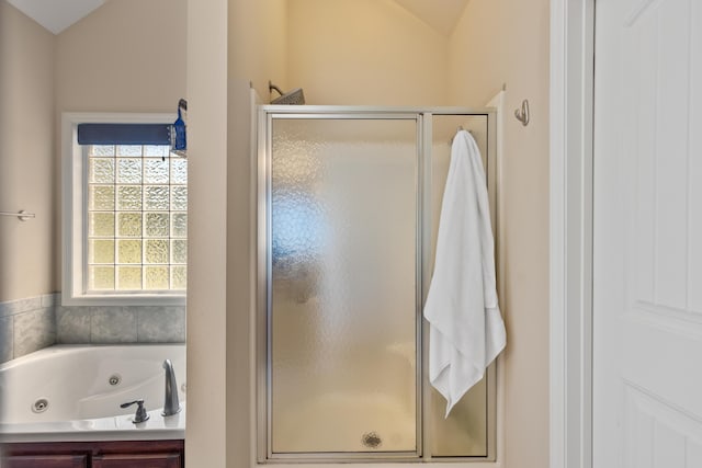 12237 Wildlife Pl, Soddy Daisy, TN 37379 - full bathroom with lofted ceiling, a jetted tub, and a stall shower