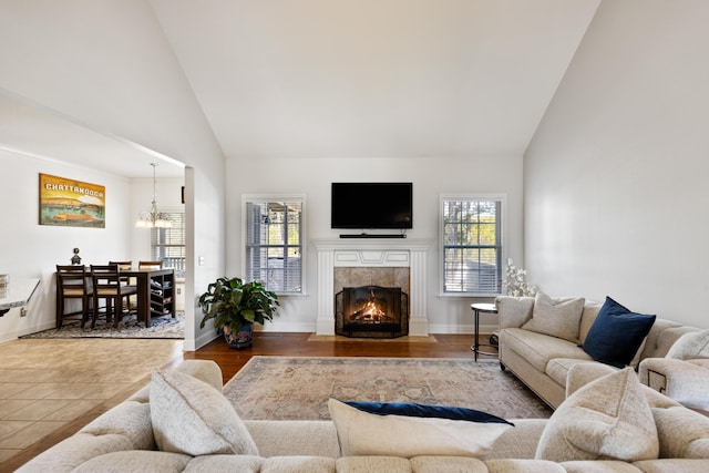 12237 Wildlife Pl, Soddy Daisy, TN 37379 - living area featuring a fireplace, high vaulted ceiling, a notable chandelier, and a healthy amount of sunlight