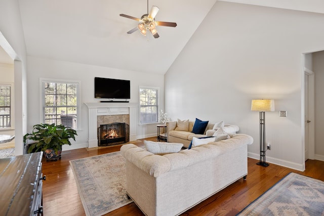 12237 Wildlife Pl, Soddy Daisy, TN 37379 - living area with a tile fireplace, wood finished floors, high vaulted ceiling, and ceiling fan