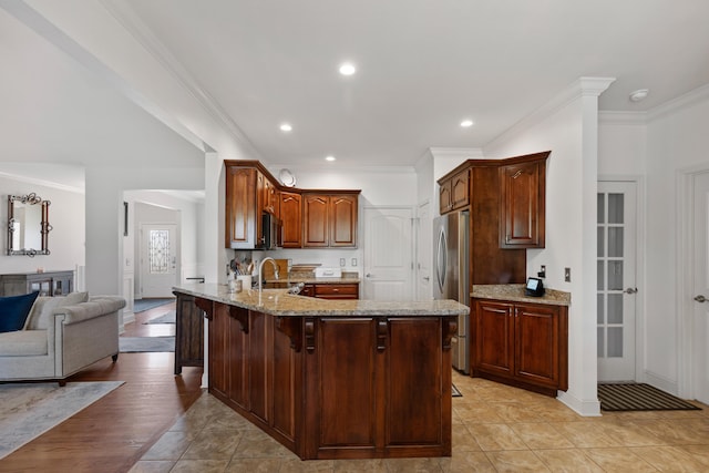 12237 Wildlife Pl, Soddy Daisy, TN 37379 - kitchen with light stone counters, a sink, crown molding, a peninsula, and appliances with stainless steel finishes