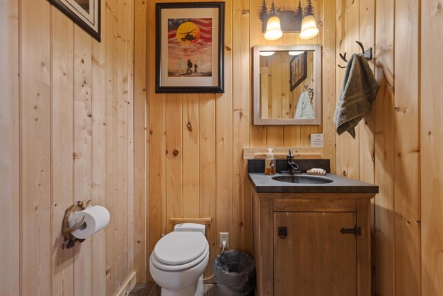 12237 Wildlife Pl, Soddy Daisy, TN 37379 - half bathroom featuring wooden walls, toilet, and vanity