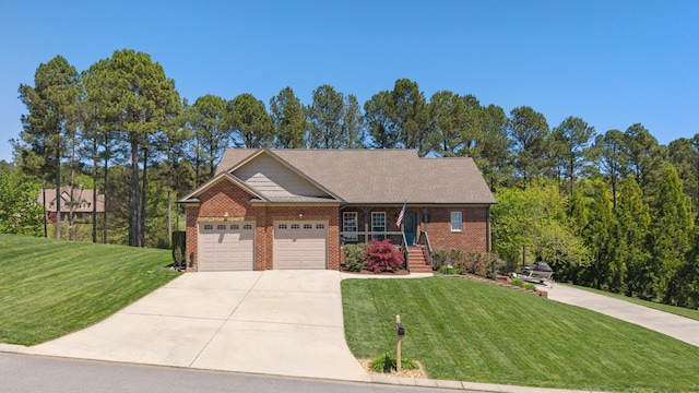 12237 Wildlife Pl, Soddy Daisy, TN 37379 - view of front of home featuring a front lawn, an attached garage, driveway, covered porch, and brick siding