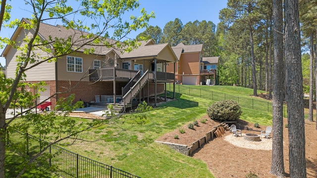 12237 Wildlife Pl, Soddy Daisy, TN 37379 - back of house featuring stairs, a fenced backyard, a wooden deck, a lawn, and a fire pit