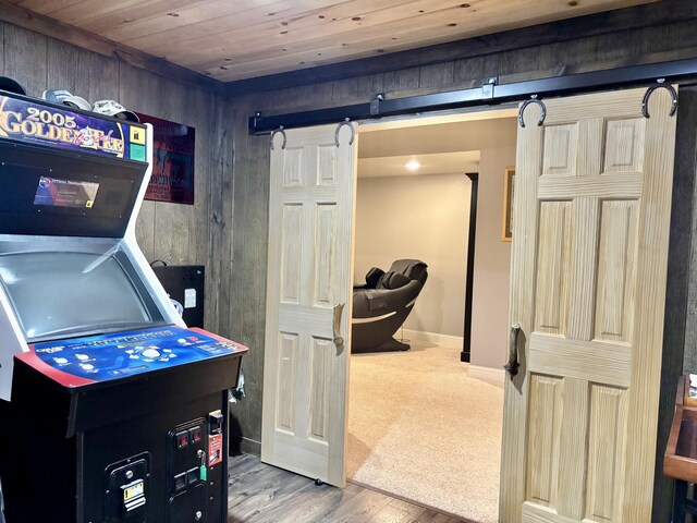12237 Wildlife Pl, Soddy Daisy, TN 37379 - playroom with a barn door, baseboards, wood ceiling, and wood finished floors