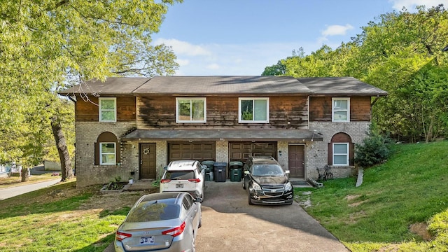 810 Forest Dale Ln, Hixson, TN 37343 - view of front of house featuring an attached garage, aphalt driveway, a front yard, and brick siding