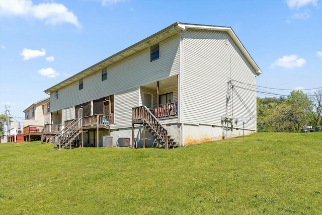 back of house with cooling unit, a lawn, and stairway