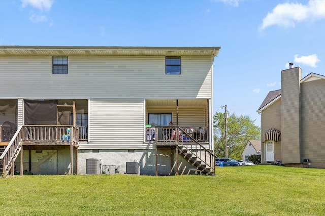 back of house with central air condition unit, a lawn, stairs, and a deck