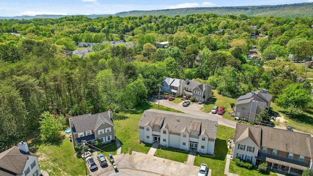 drone / aerial view featuring a residential view and a view of trees