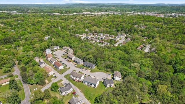 drone / aerial view featuring a residential view and a forest view