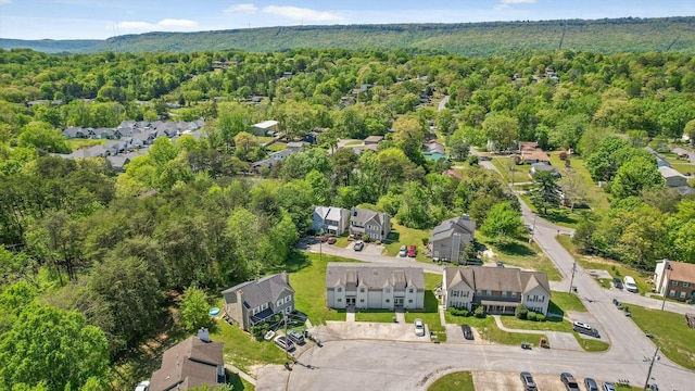 birds eye view of property featuring a residential view and a wooded view