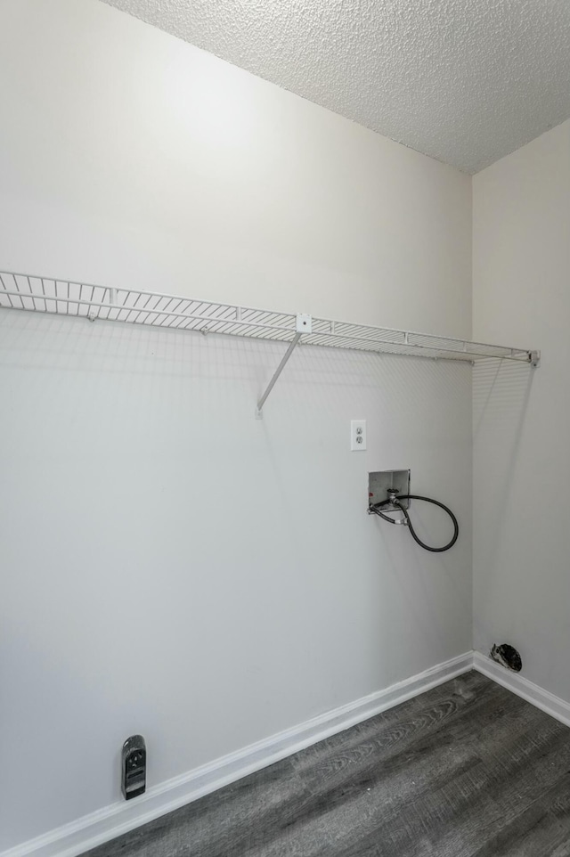 clothes washing area with baseboards, laundry area, washer hookup, and dark wood-style flooring