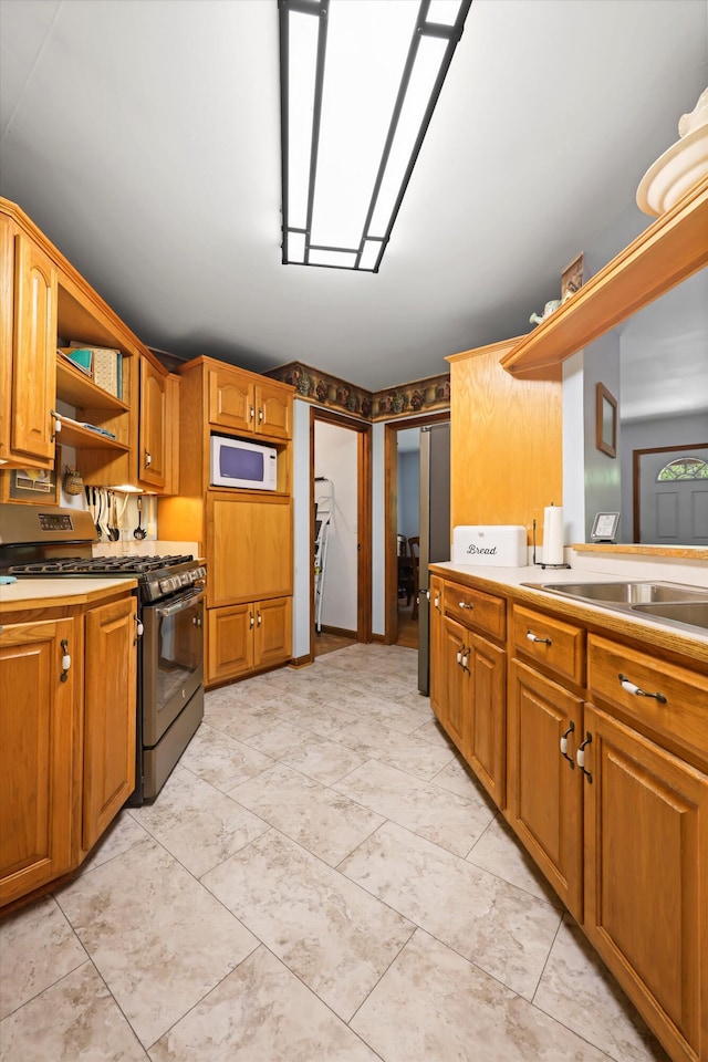 798 Deerfield Ln, Sugar Valley, GA 30746 - kitchen with open shelves, stainless steel gas stove, white microwave, and brown cabinets