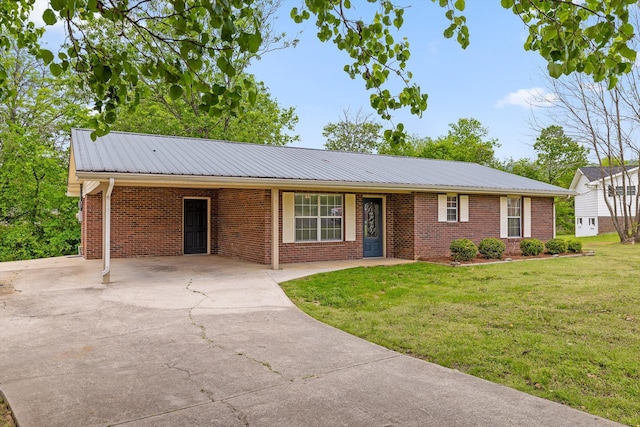 ranch-style home with concrete driveway, a front lawn, an attached carport, and brick siding