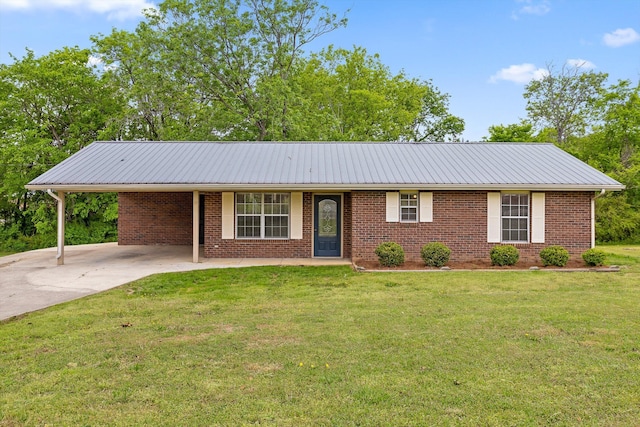 ranch-style house with brick siding, a carport, a front lawn, and driveway