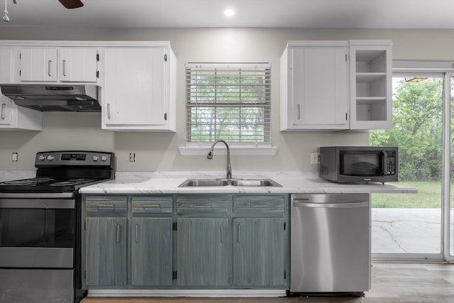 kitchen with white cabinetry, open shelves, a sink, appliances with stainless steel finishes, and under cabinet range hood