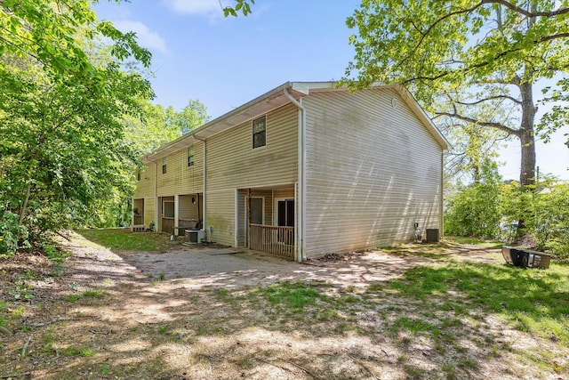 rear view of house featuring central AC