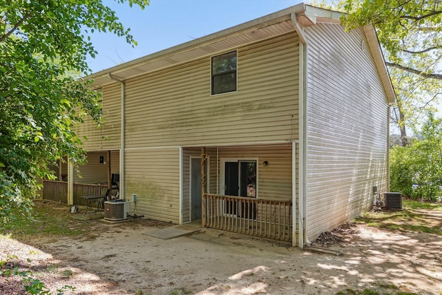 rear view of house featuring central AC