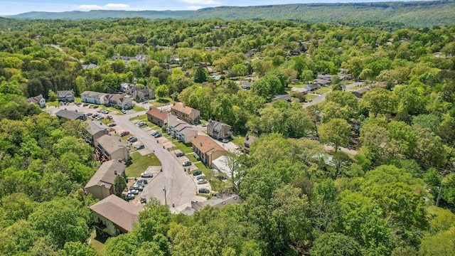 birds eye view of property with a view of trees