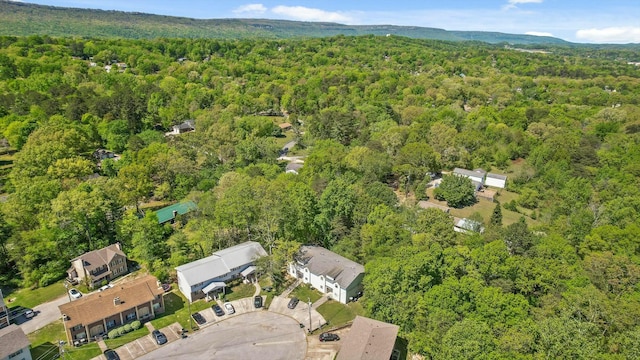bird's eye view with a wooded view