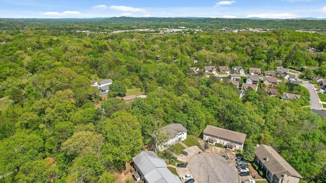 birds eye view of property featuring a view of trees