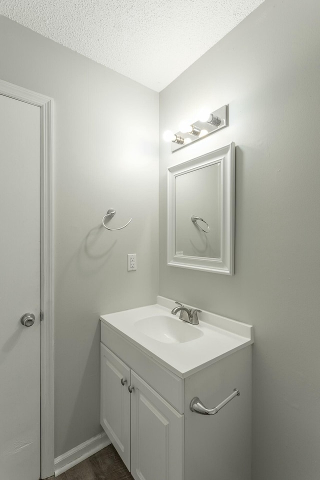 bathroom with vanity and a textured ceiling