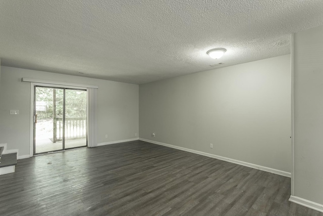 unfurnished room with dark wood-type flooring, a textured ceiling, baseboards, and visible vents