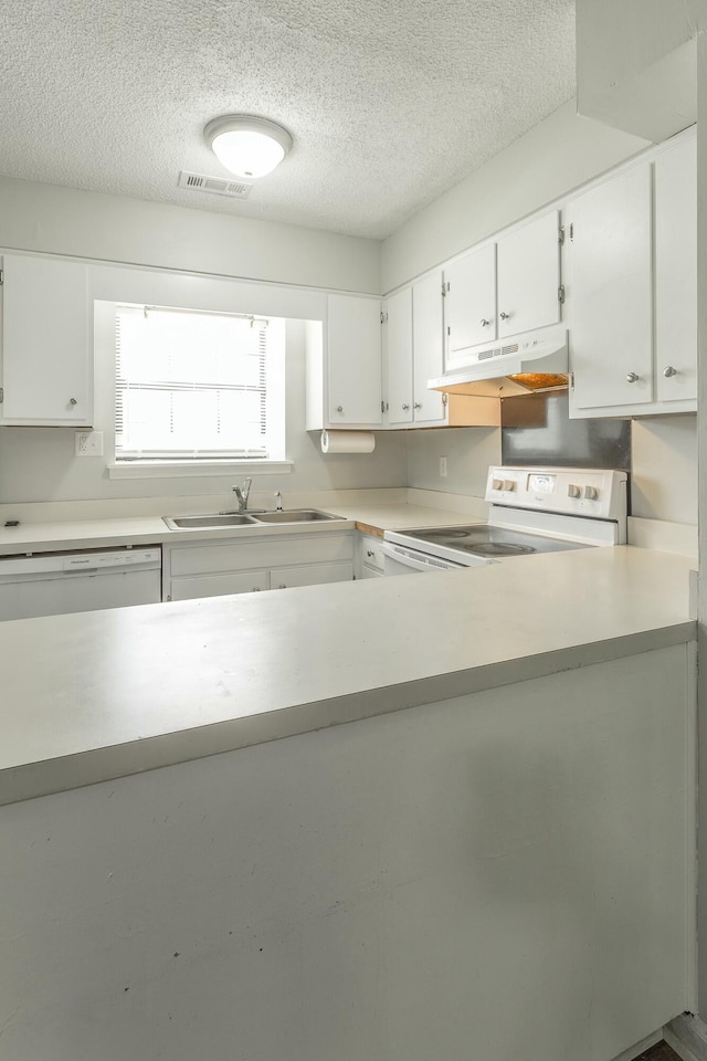 kitchen with under cabinet range hood, visible vents, white appliances, and a textured ceiling