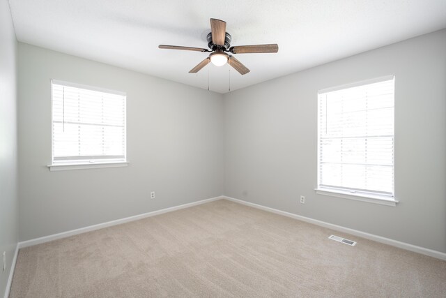 4802 Woodland Cir, Hixson, TN 37343 - empty room featuring light carpet, a ceiling fan, visible vents, and baseboards