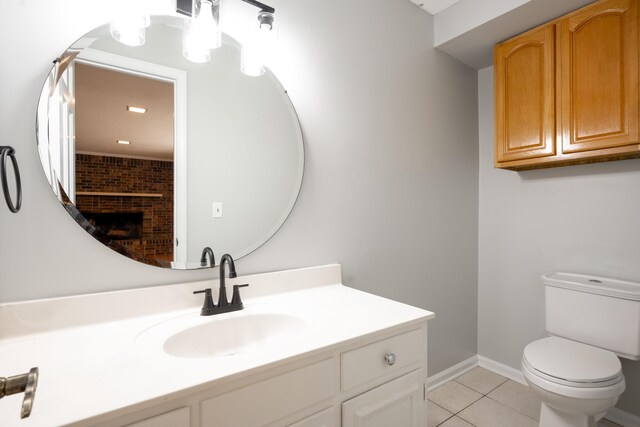 4802 Woodland Cir, Hixson, TN 37343 - bathroom featuring tile patterned floors, toilet, baseboards, a brick fireplace, and vanity