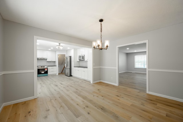 4802 Woodland Cir, Hixson, TN 37343 - unfurnished dining area featuring light wood-style flooring, baseboards, recessed lighting, and a chandelier