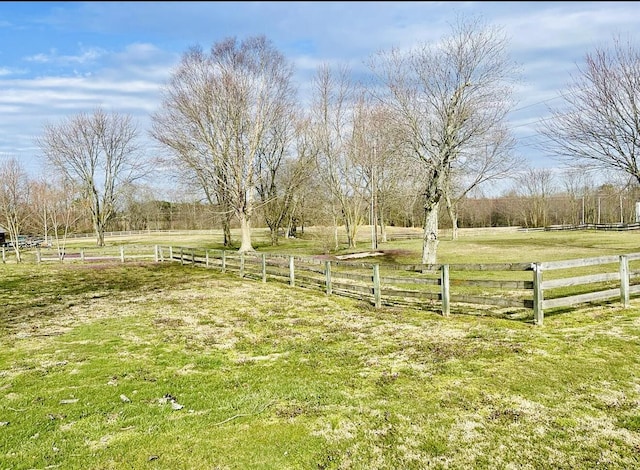 view of yard featuring fence and a rural view
