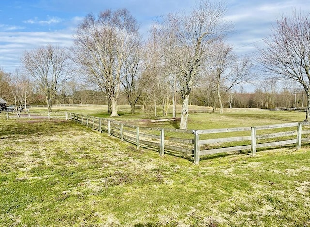 view of yard with a rural view and fence
