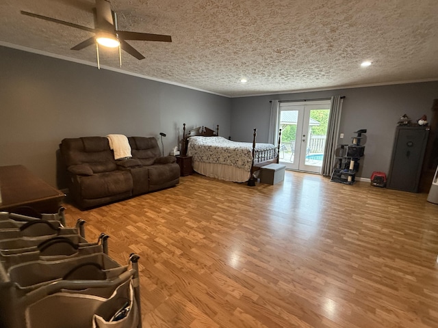 bedroom featuring wood finished floors, access to exterior, a textured ceiling, french doors, and crown molding