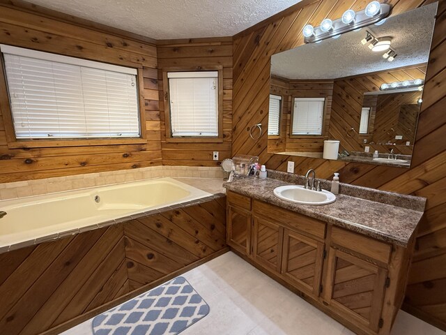 full bath with wood walls, a textured ceiling, a garden tub, and vanity