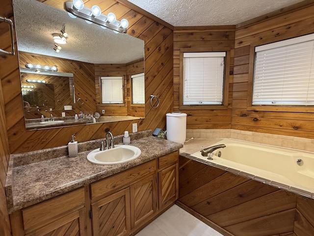 bathroom featuring wooden walls, a textured ceiling, and a garden tub